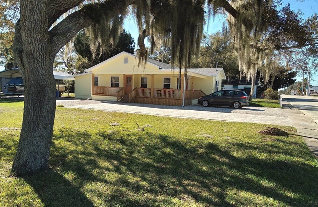 Charming 3 bedroom 2 bath home w/wraparound veranda on one acre of land.