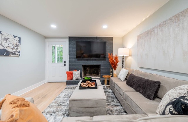Charming cottage entrance with cozy curb appeal, nestled in a peaceful and green setting.