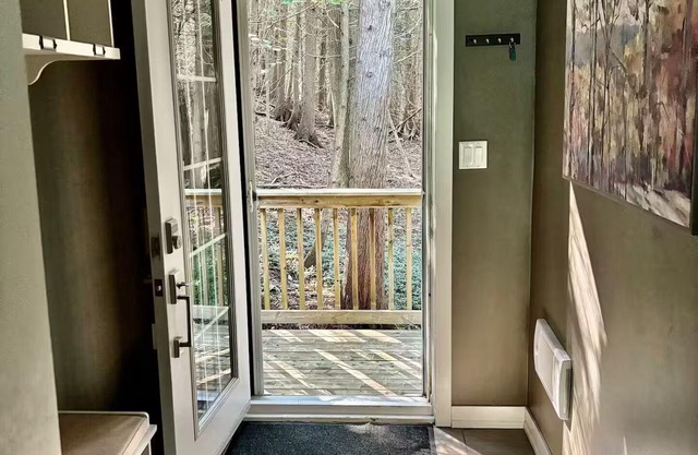Charming updated A-frame home nestled in the woods adjacent to Kimberley Creek.
