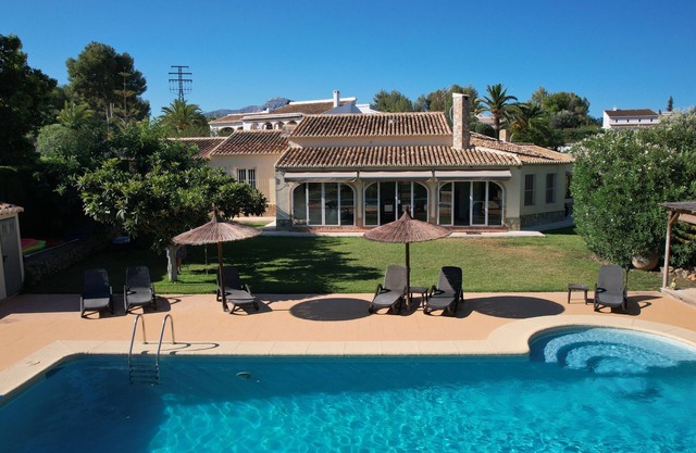 Charming Villa on one level with large pool, lawns, and tennis court