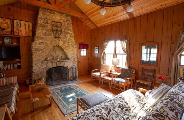 Classic cabin/cottage with big screen porch, stone fireplace, knotty pine walls.