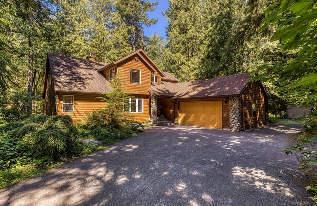 Classic riverfront home w/great views, game room, hot tub, & modern cabin feel