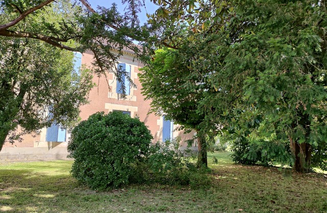 Country house with wooded garden in the heart of a village