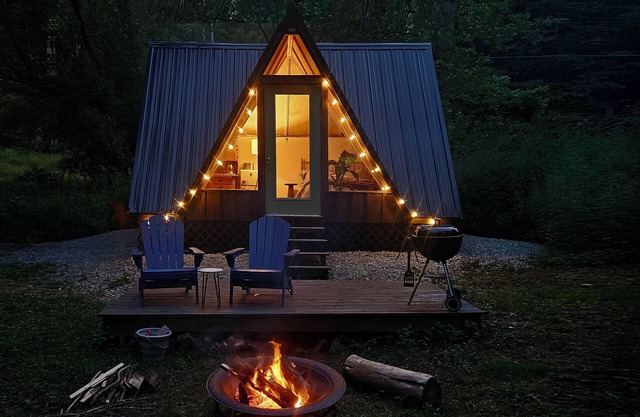 Cozy A-frame cabin surrounded by trees in Keene