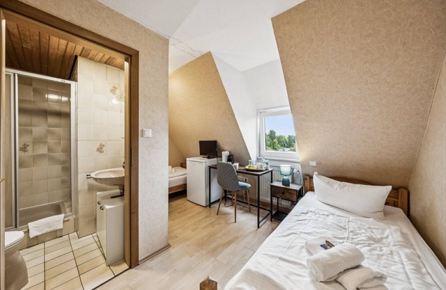 Cozy double room, flat-screen TV, and modern bathroom with shower. Ideal for couples and short stays – enjoy a relaxed atmosphere with warm wood accents and coastal charm.