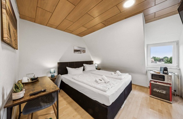 Cozy double room, flat-screen TV, and modern bathroom with shower. Ideal for couples and short stays – enjoy a relaxed atmosphere with warm wood accents and coastal charm.