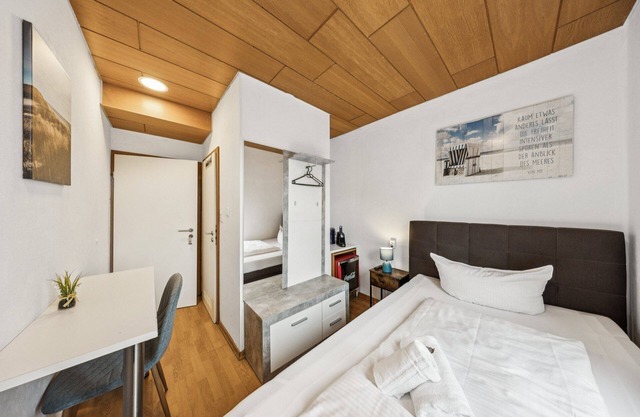 Cozy single room, flat-screen TV, and modern bathroom with shower. Ideal for singles and short stays – enjoy a relaxed atmosphere with warm wood accents and coastal charm.
