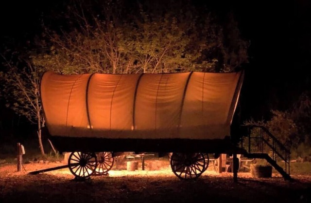Cozy Wild West Covered Wagon next to River