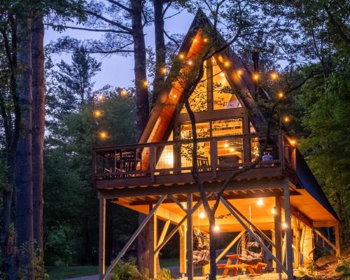 Designer A-Frame Treehouse with hot tub on river