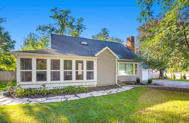 Elegant 2-story home with heated pool, hot tub, deck, large lawn, & pool house