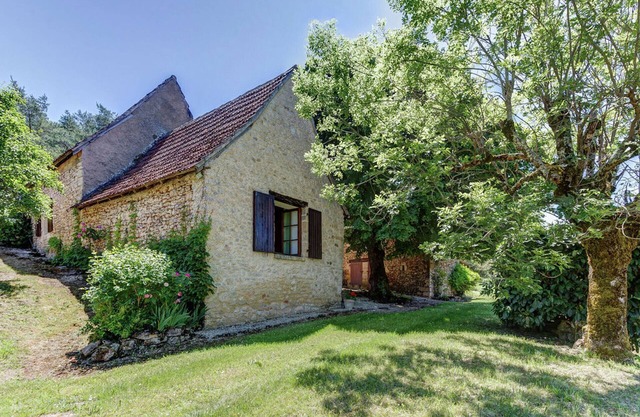 House with a large garden surrounded by nature