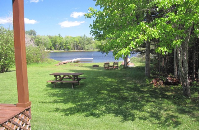 Lakefront, covered deck, huge backyard with grill, swimming, boat & kayaks!