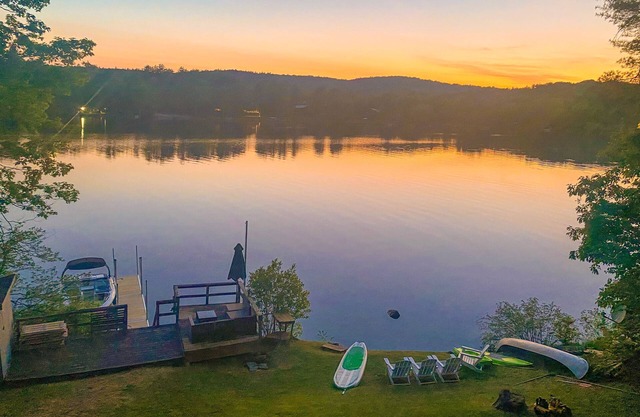Lakefront home near ski resorts with water view, dock, deck, fireplaces, & W/D
