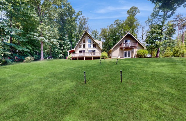 Lakefront property with beach, dock, game tables, guest house, grill, W/D, & AC