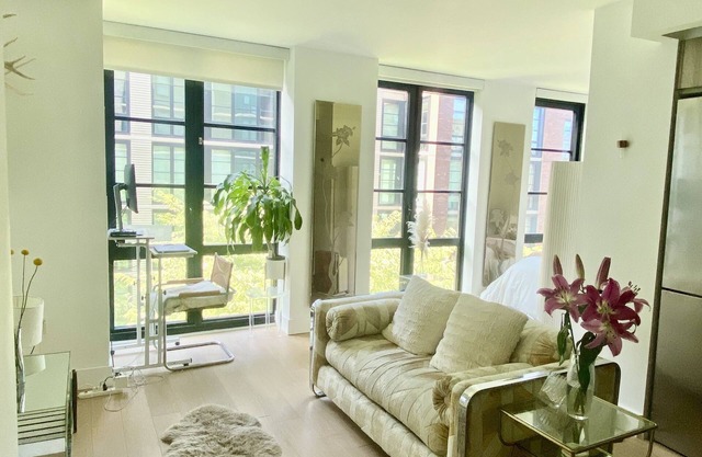 Large Alcove Sundrenched Studio in Luxury Doorman Building Prime Location