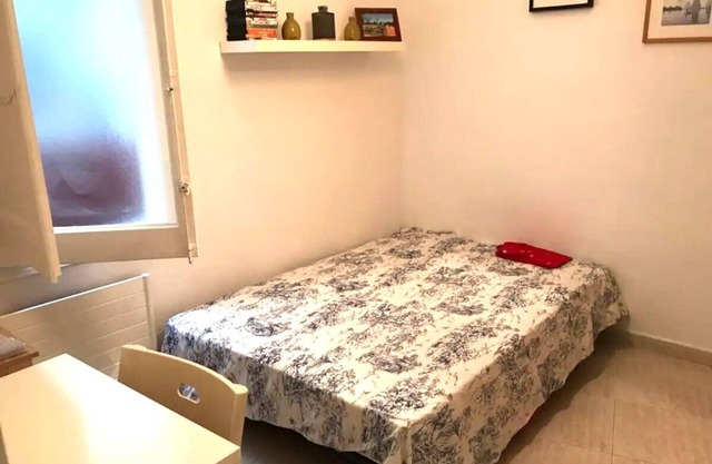Large double bedroom with desk, double bed, large wardrobe and window.