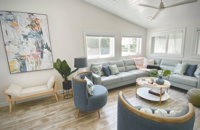 Modern coastal getaway with hot tub, putting green and private backyard oasis.