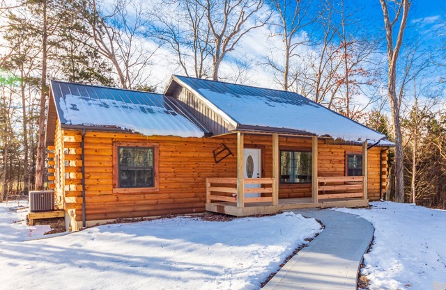 New 3 Bedroom Log Cabin nestled in the woods with one acre fishing lake .