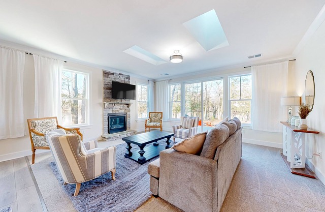 Newly built riverfront home with dock, kayaks, basketball court, & game room