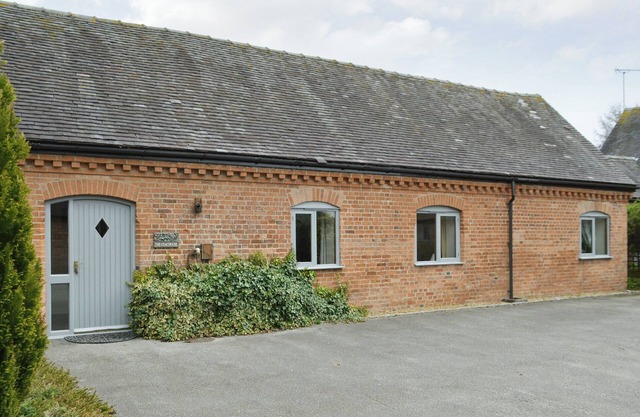 One of two barn conversions with exposed beams and trusses.