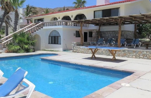 Private beachfront pool, airy & open living area leading to an outdoor oasis