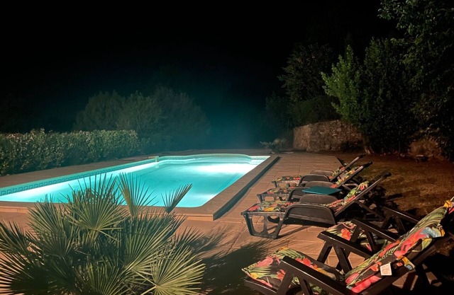 Provencal house with swimming pool surrounded by olive and pine trees