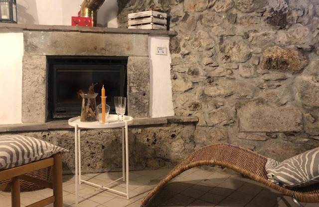 Rustic apartment with beams and stone.