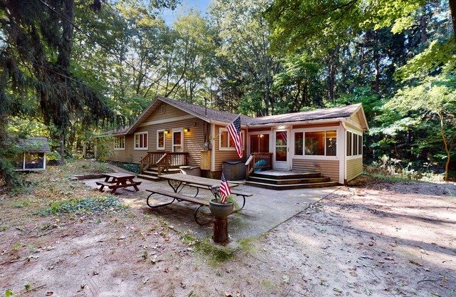 Serene Lake Michigan home with private beach access, wooded land, near town.