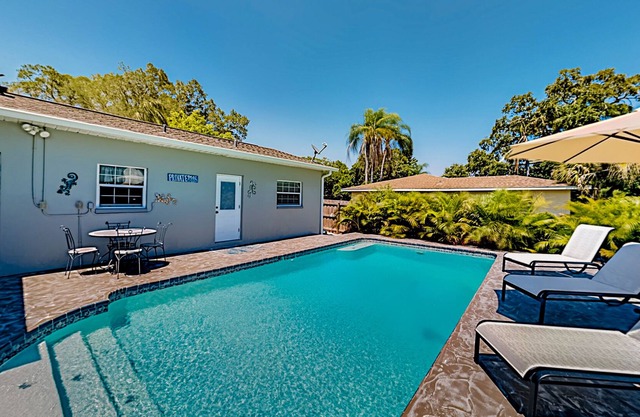 Single-story home with outdoor dining, firepit, home office & laundry room