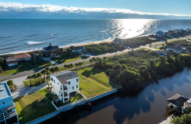 Spacious 5-bedroom house on water, beach access, hot tub, elevator, game room!