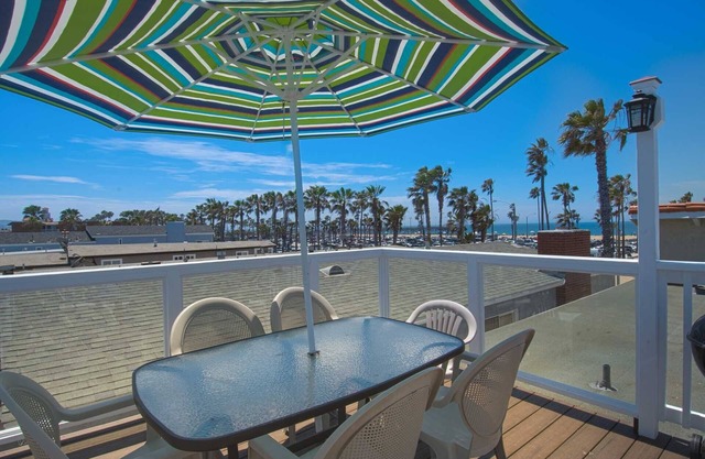 Spacious upper rear unit in an oceanfront triplex just steps from the Balboa Pier fun!