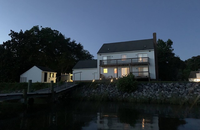 Spacious waterfront home with dock and sunset view