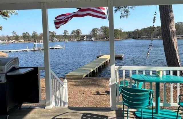 Steps from the water with a private dock, a big relaxing porch & great amenities