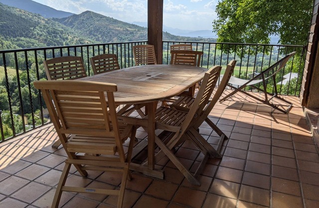 Sunlight and quiet. Mountains, thermal baths and pool in summer. Panoramic view.