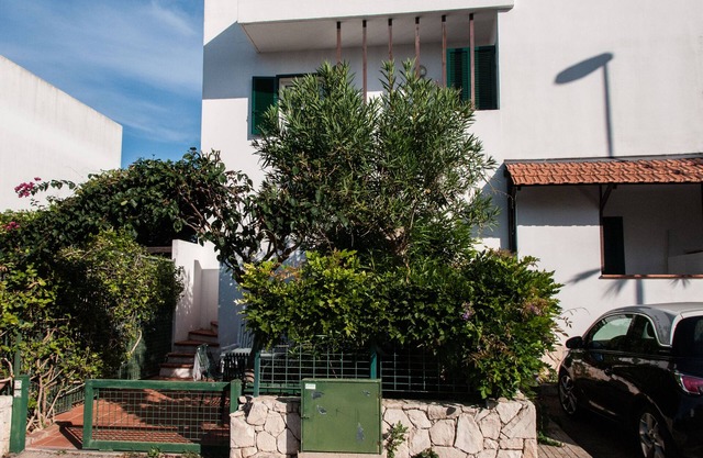 terraced house in a holiday village near Gallipoli, surrounded by greenery.