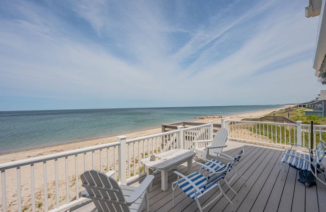 The world of sun and sand beckons from every corner of this grand beachfront home