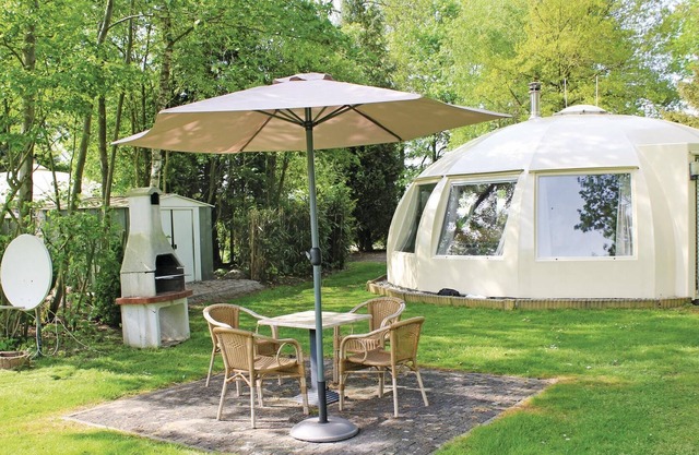 These detached bungalows with domed roofs are scattered in a wooded resort.