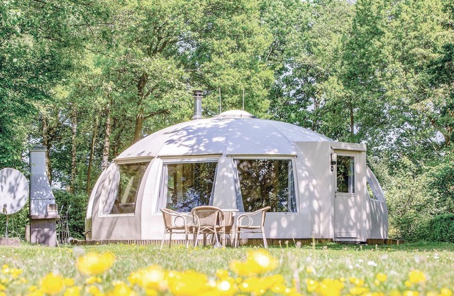 These detached bungalows with domed roofs are scattered in a wooded resort.