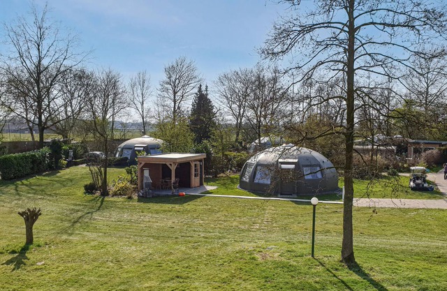 These detached bungalows with domed roofs are scattered in a wooded resort.