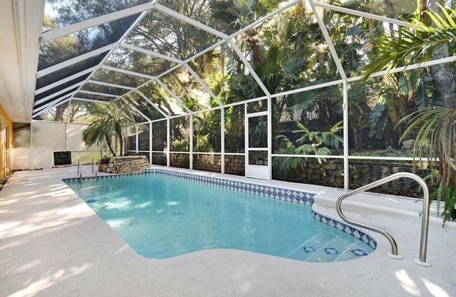 This beauty is centrally located, with a heated pool and water fall!