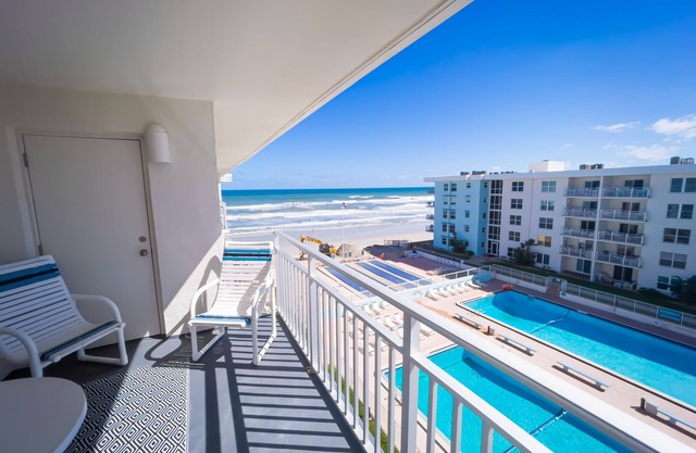 Top-floor condo with ocean/pool views, private balcony, and heated beachfront pool