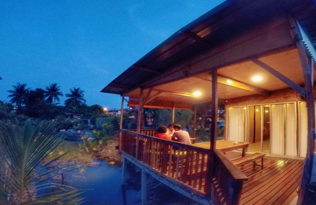 Tung's Tropika - with a wooden hut by a lake