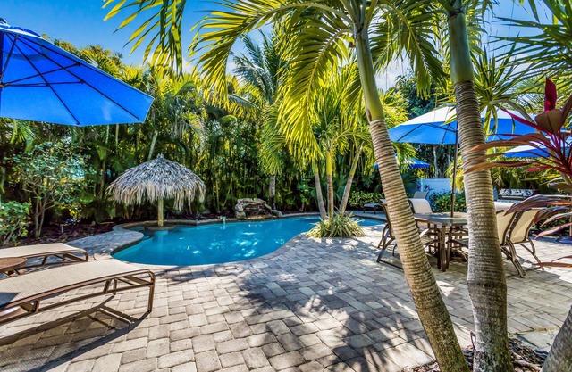 Vibrant Island Retreat with Pool, Tiki Table and Walk to Beach
