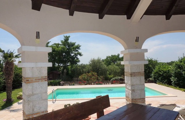 Villa house with sea view and pool surrounded by lush gardens above Poreč