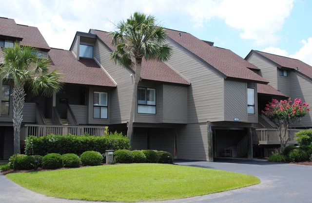 Villa with marsh views and pool access located within gated Litchfield By the Sea community.