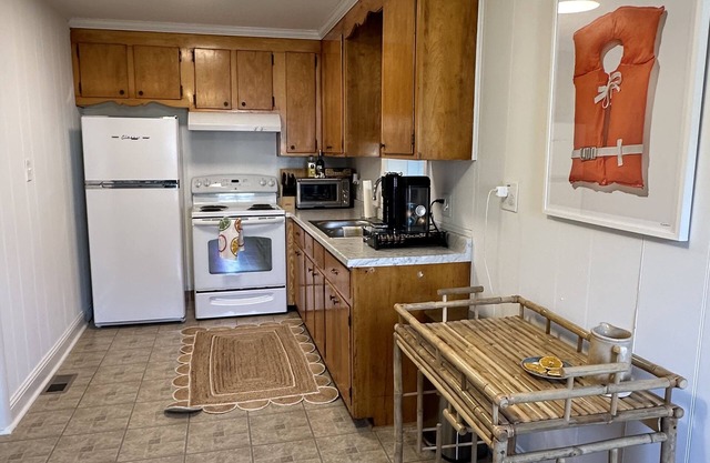 Walk to town from this cozy Rivah house with awesome yard and water views.