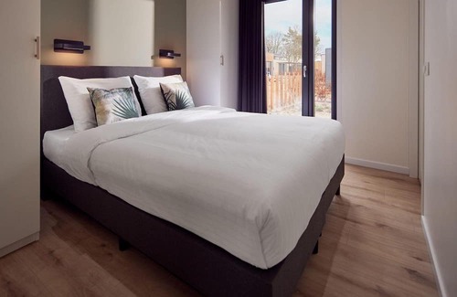 Lattrop House | The Amalia is a four-person holiday home and has an attractive homely living room with an open kitchen, two bedrooms and a spacious outdoor area.