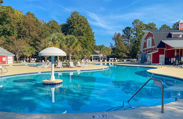 Charming & sunlit retreat with pool, patio, courts, & gym - near golf & beaches, dog-friendly