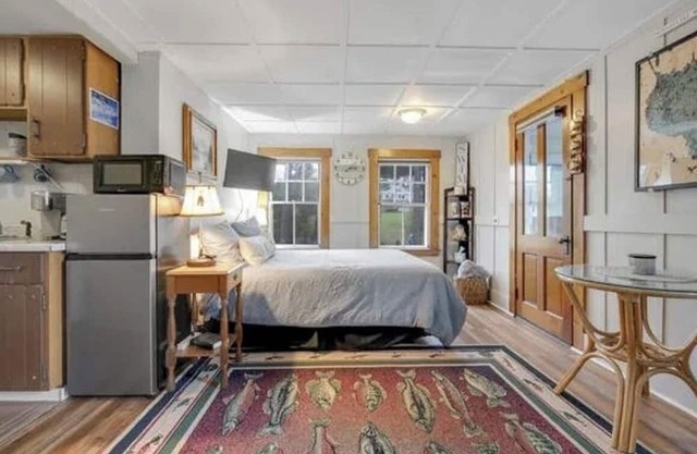 Sebago Lake studio-style condo with enclosed sunroom and sunset views
